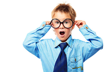 Little boy in spectacles and suit pointing the finger at something. Isolated over white background.