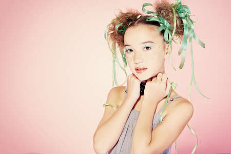 Portrait of a happy funny girl with holiday make-up, hairstyle and dress.の写真素材
