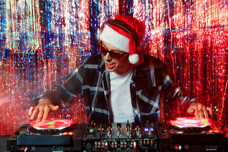 DJ mixing up some Christmas cheer. Disco lights in the background. 