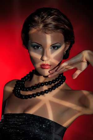 Art portrait of a beautiful young woman. Retro style.  Light and shadow.の写真素材