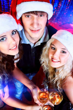 Group of cheerful young people celebrating Christmas at the party.の写真素材