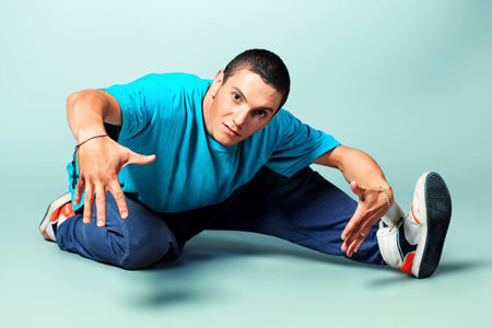 Trendy young man dancing hip-hop at studio.