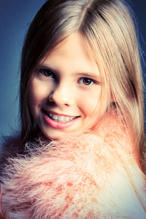 Beautiful little girl in festive dress posing at studio.の写真素材