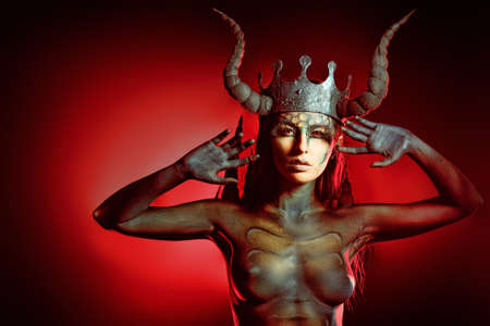 Beautiful and scary devil woman. Art project.の写真素材