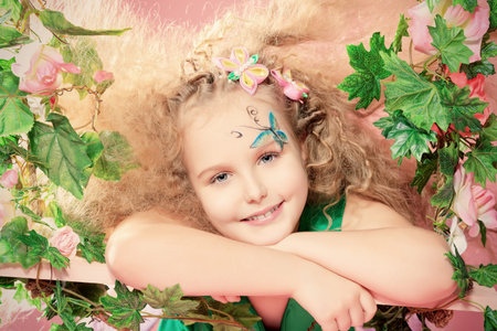 Beautiful little fairy among the thickets of ivy over pink background.の写真素材