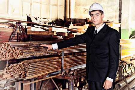 Industrial theme: businessman at a manufacturing area.