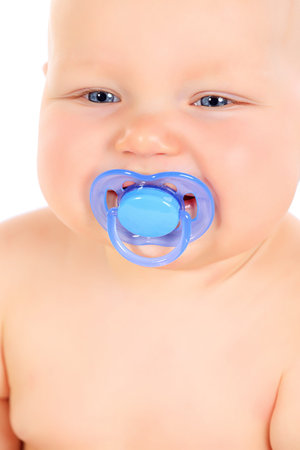 Close-up portrait of cute small baby holding his dummy. Isolated over white.