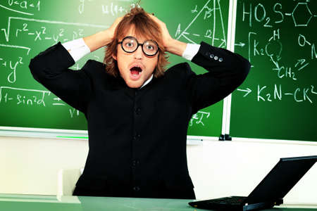 Portrait of a shocked male student grabbed his head. の写真素材