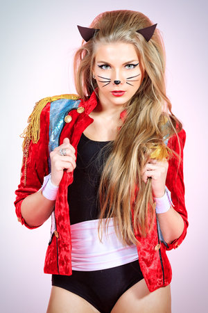 Sexy playgirl in pussycat costume alluring over pink background.の写真素材