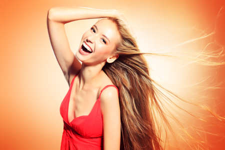 Beautiful laughing blonde woman with magnificent hair.の写真素材