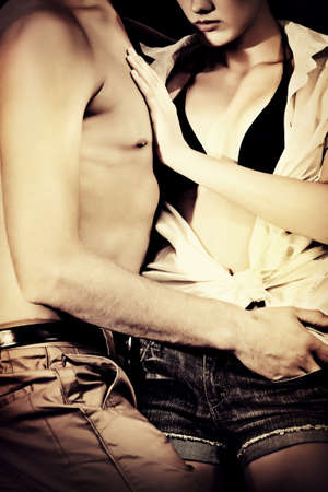 Close-up of a beautiful young couple in love embracing outdoor.の写真素材