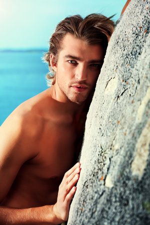 Portrait of a handsome male model posing at the seaside. の写真素材