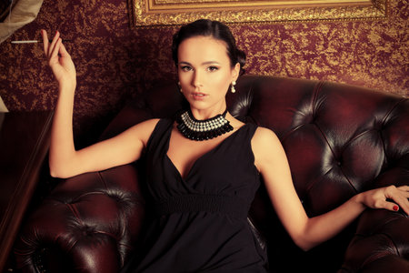 Beautiful young woman in a  luxurious classic interior.