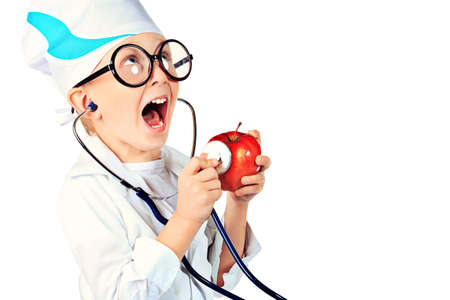 Portrait of a cute boy playing doctor with a stethoscope. Isolated over white.の写真素材