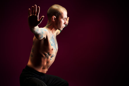 Handsome man shows different yoga exercises over black background.
