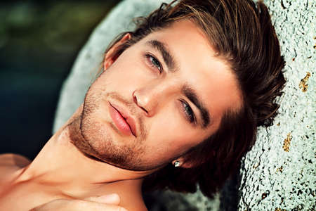 Portrait of a handsome male model posing at the seaside. の写真素材