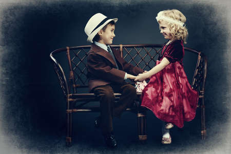 Cute little boy admitted in love the charming little lady. Retro style.の写真素材