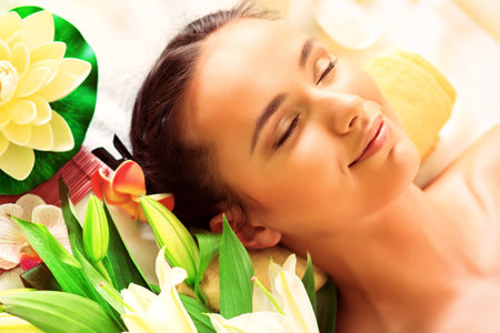 Beautiful young woman taking spa treatments at the salon.の写真素材