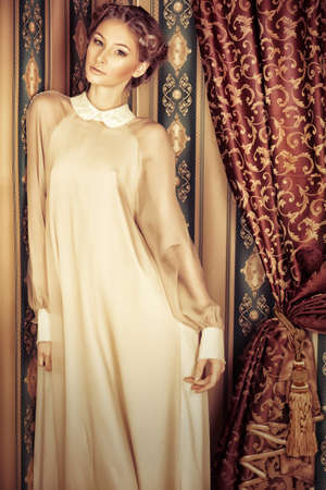 Charming fashionable model posing in the vintage interior.の写真素材