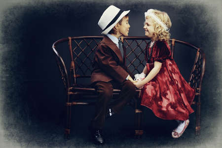 Cute little boy admitted in love the charming little lady. Retro style.の写真素材