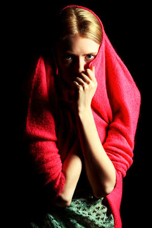 Fashion model posing at studio over black background. の写真素材