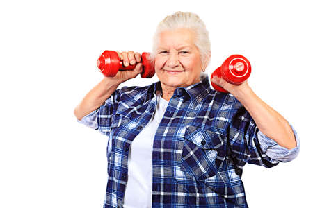 Happy grandma doing exercises with dumbbells. Isolated over white.の写真素材