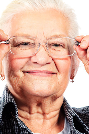 Happy senior woman smiling at the camera. Isolated over white.
