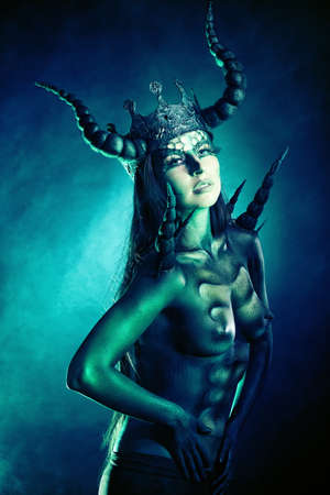Beautiful and scary devil woman. Art project.の写真素材