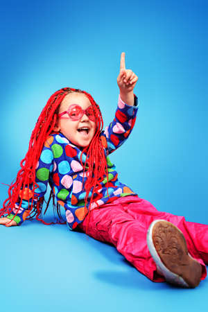 Portrait of a trendy little girl wearing red braids and modern clothes.の写真素材