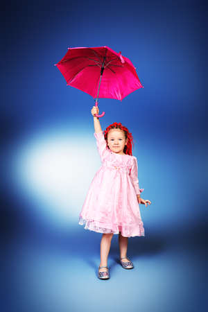 Full length portrait of a cute little girl wearing modern braids and pink dress.の写真素材