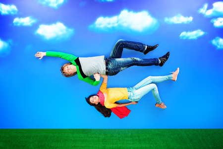 Couple of young people in love flying in the sky.の写真素材