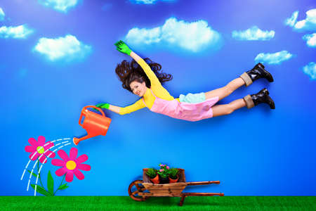 Romantic young woman is growing fabulous flowers.の写真素材