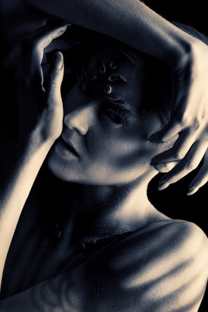 Art project: expressive young woman with beautiful painted body.
