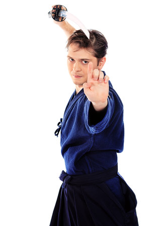 Handsome young man practicing kendo. Isolated over white.の写真素材