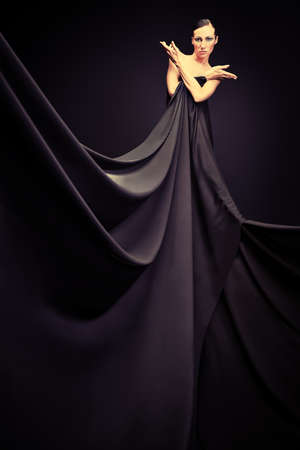 Art fashion photo of a beautiful woman in black dressの写真素材