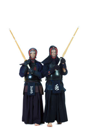 Two kendo fighters posing together over white background. Asian martial arts.の写真素材