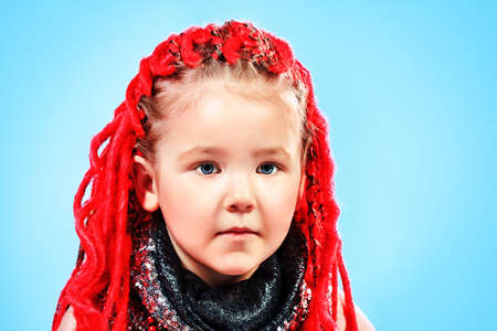Portrait of a trendy little girl wearing red braids.の写真素材