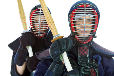 Two kendo fighters posing together over white background. Asian martial arts.の写真素材