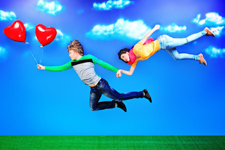 Couple of young people in love flying in the sky.