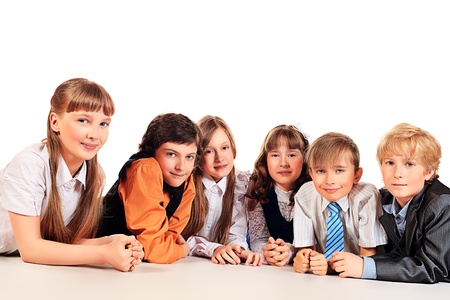 Group of cheerful children lying on a floor together. Isolated over white.の写真素材