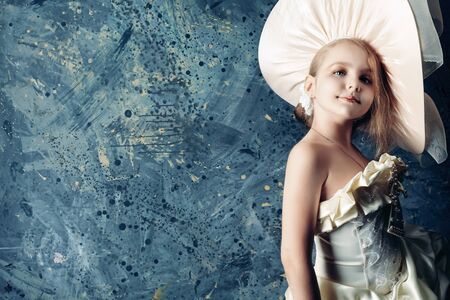Portrait of a charming little lady in a beautiful elegant dress. の写真素材
