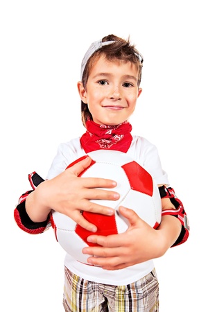 Active boy standing with a football. Isolated over white.の写真素材