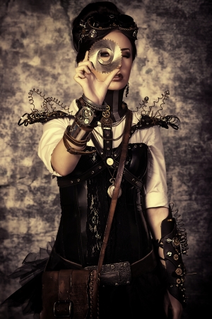 Portrait of a beautiful steampunk woman over grunge background.の写真素材