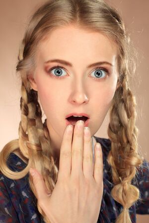 Portrait of a funny pretty blonde girl posing at studio. Retro style.の写真素材