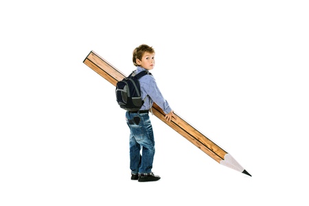 A boy standing with a huge pencil. Education. Isolated over white.の写真素材