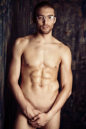 Sexual muscular man posing over dark background.の写真素材