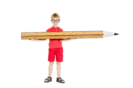 Cute boy standing with a huge pencil. Education. Isolated over white.の写真素材