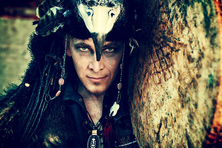 Portrait of a shaman with a drum outdoor. の写真素材