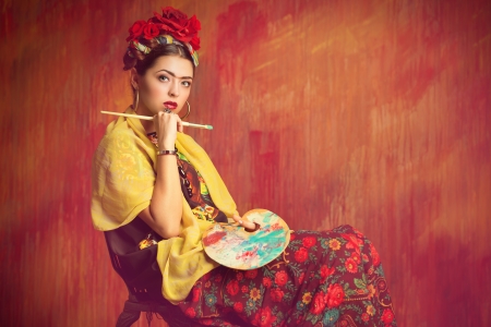 Portrait of an old-fashioned woman painter holding a palette and brush. の写真素材