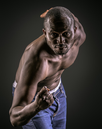 Handsome muscular african american man. Over black background.の写真素材
